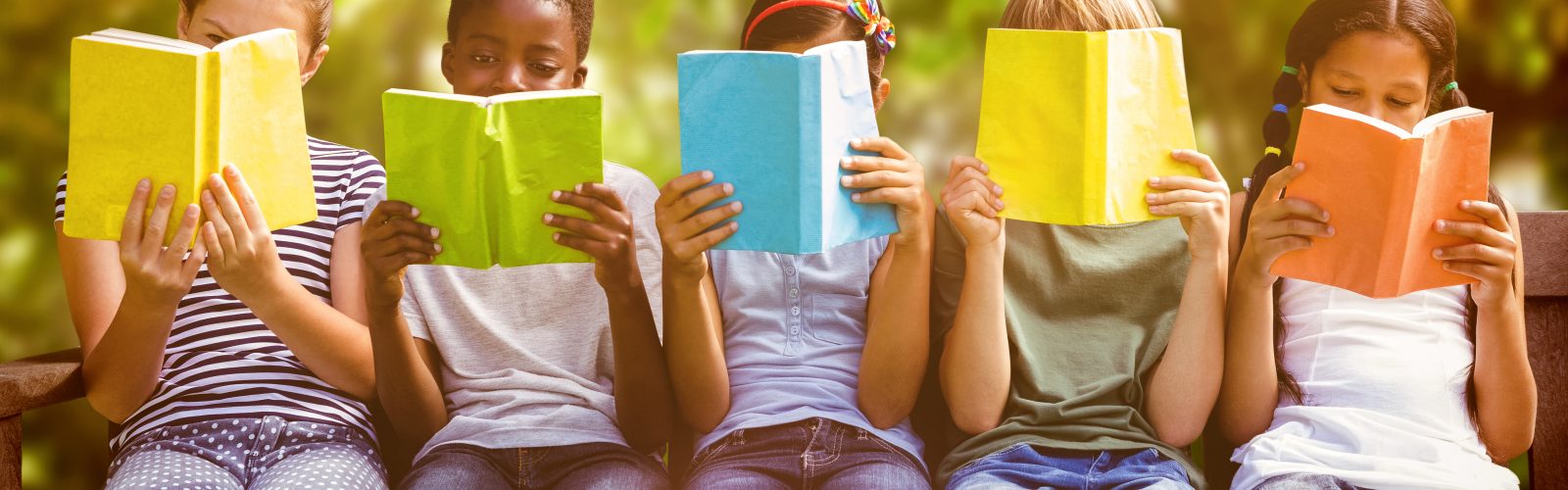 Five children reading books outside